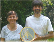Tom & Nancy holding a healing disc.